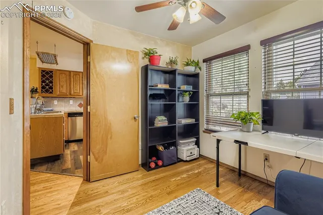 a living room with furniture and a book shelf
