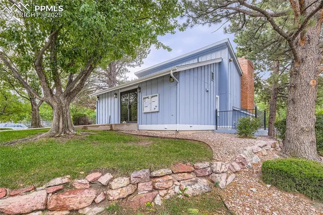 a backyard of a house with table and chairs