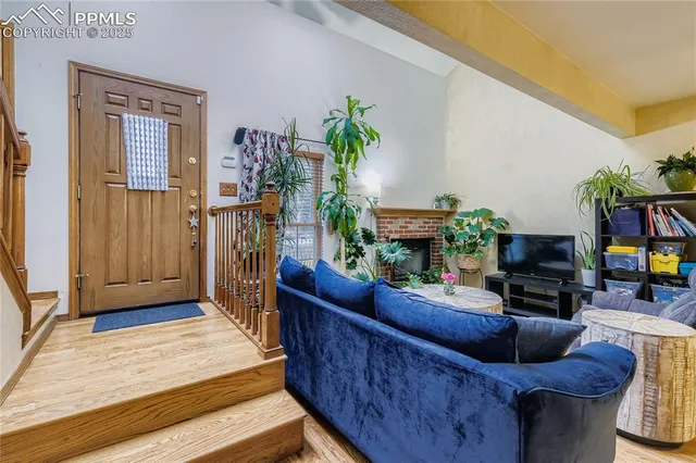 a living room with furniture a flat screen tv and a fireplace