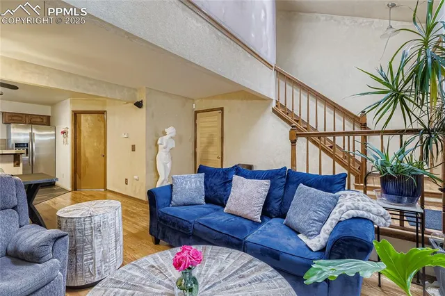 a living room with furniture flowerpot and wooden floor