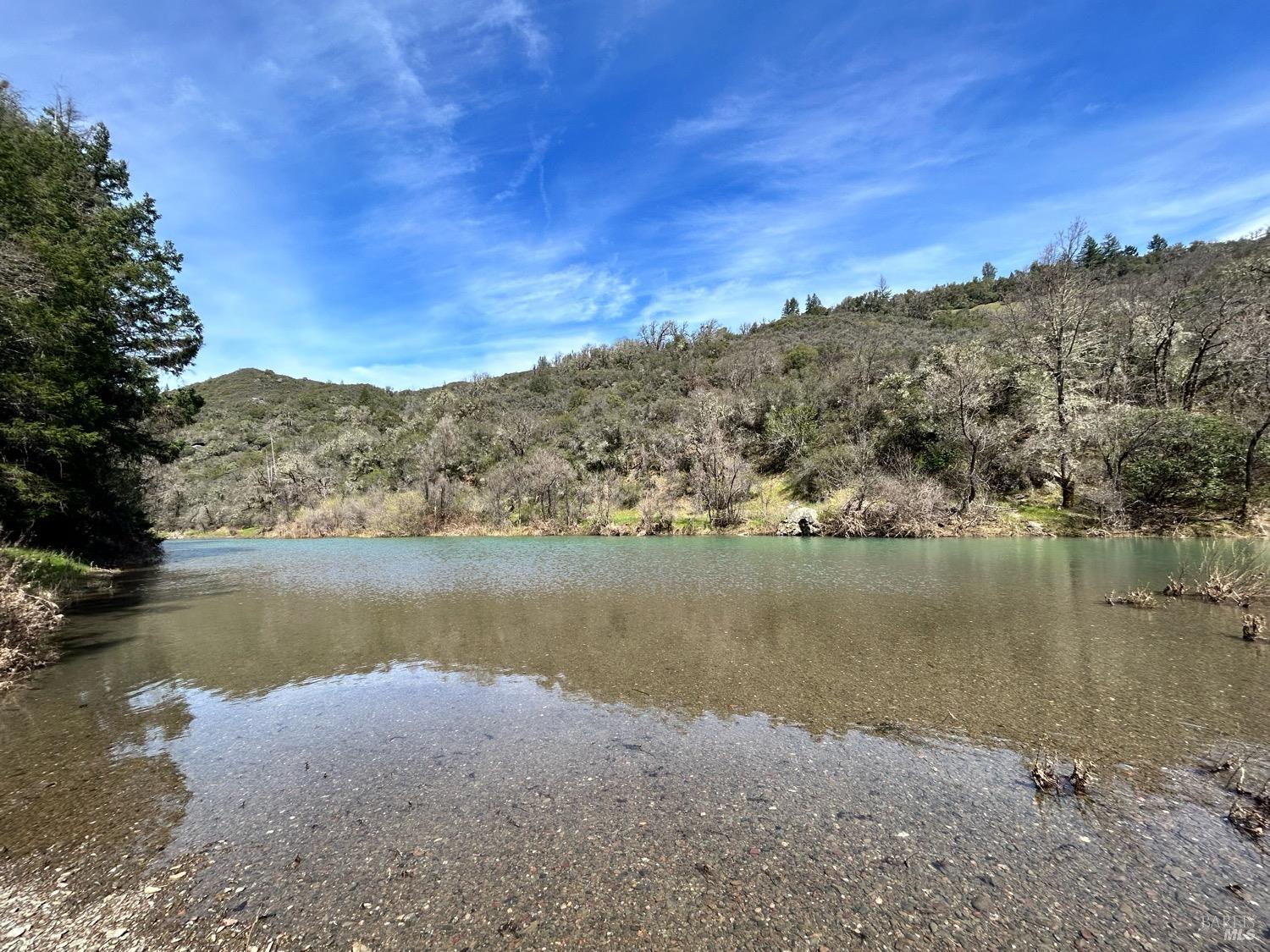 21165 Tomki Road Willits, CA 95490 - Photo 23 of 23 a view of a lake with a mountain in the background