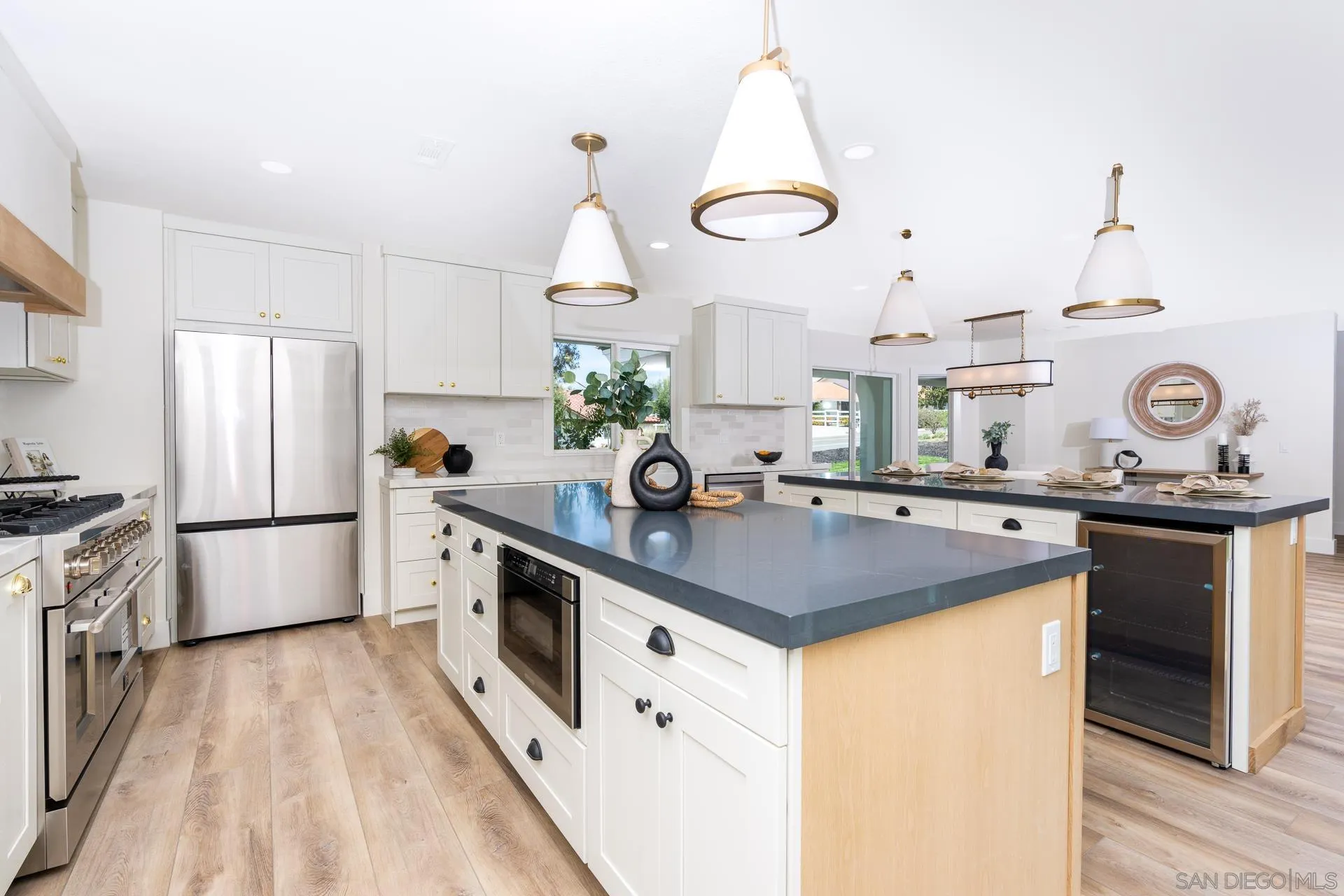 30603 Del Rey Road Temecula, CA 92591 - Photo 14 of 58 a kitchen with kitchen island white cabinets and refrigerator