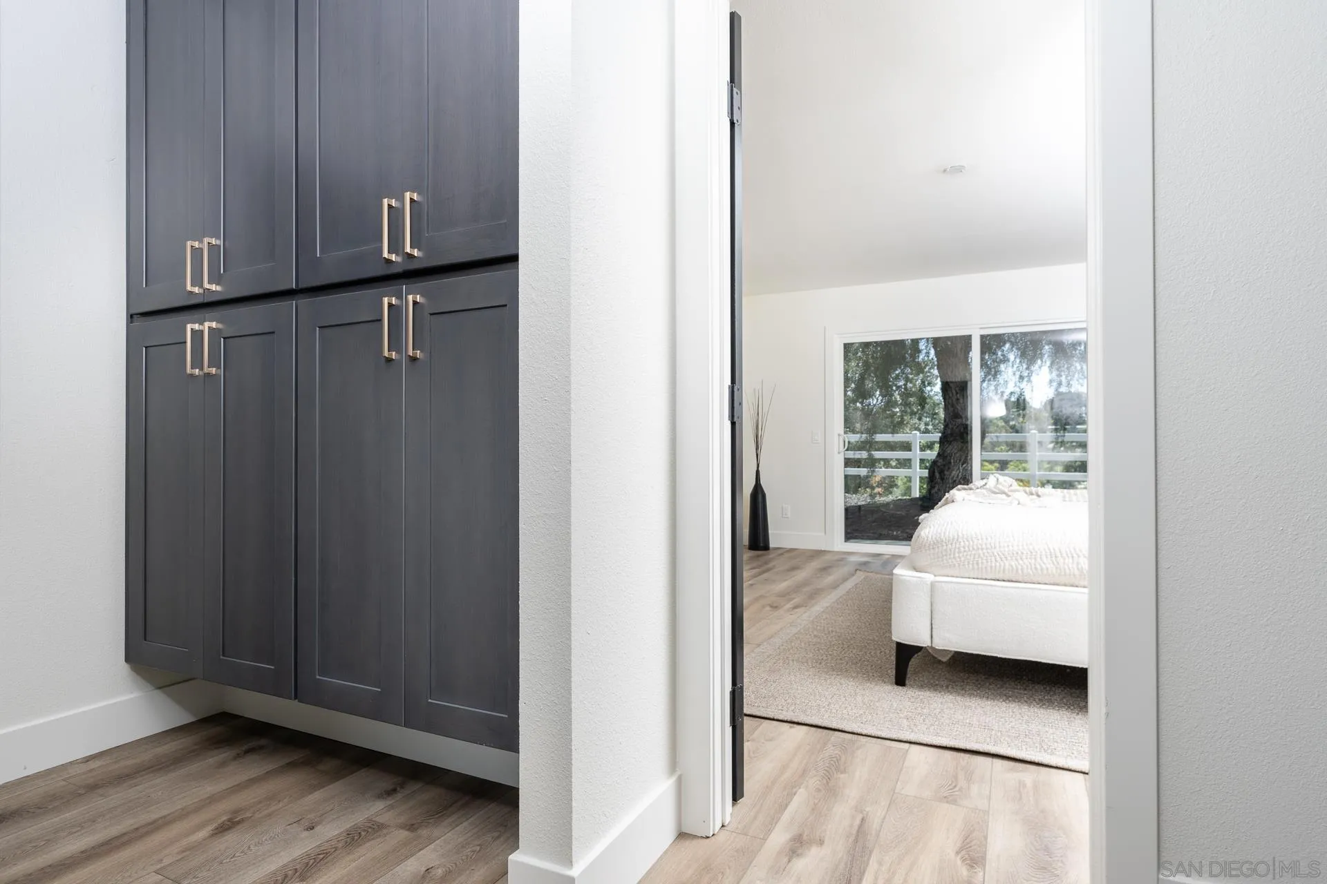 30603 Del Rey Road Temecula, CA 92591 - Photo 28 of 58 a bedroom with a bed and wooden floor