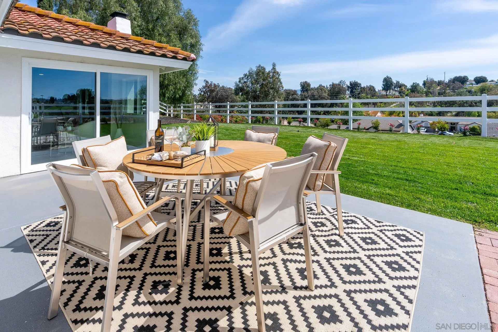 30603 Del Rey Road Temecula, CA 92591 - Photo 39 of 58 a view of a patio with table and chairs with wooden floor and fence