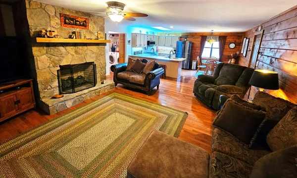 a kitchen with stainless steel appliances granite countertop a refrigerator a stove top oven a sink and dishwasher