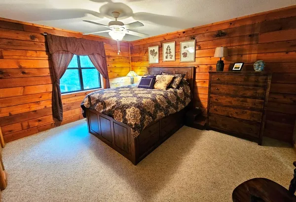 a bedroom with a bed and a window