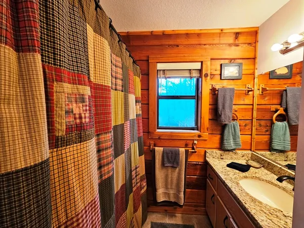 a view of a hallway with wooden floor and stairs