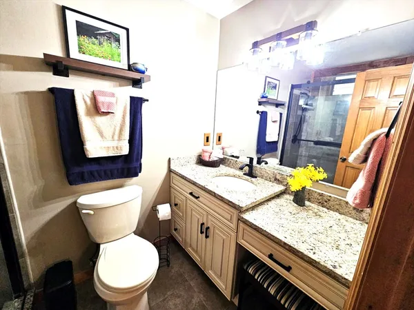 a bathroom with a shower and a sink