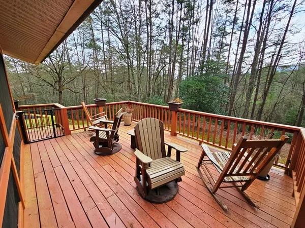 a view of sitting area with chairs on wooden deck