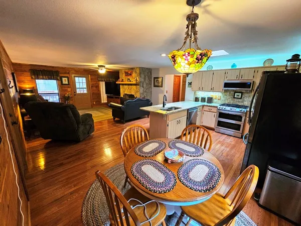 a view of a dining room with furniture and a chandelier