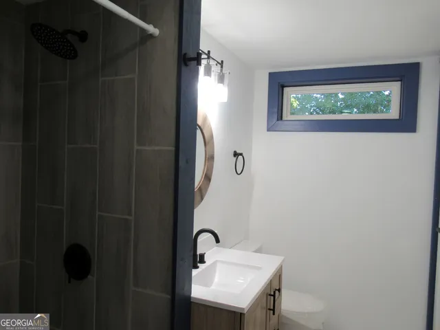a bathroom with a sink and mirror