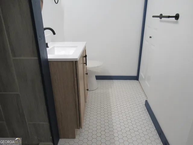 a view of bathroom with a sink and mirror
