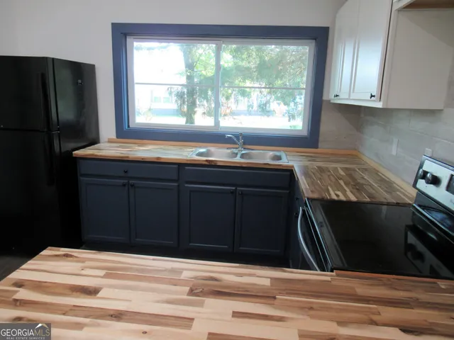 a kitchen with a sink and cabinets