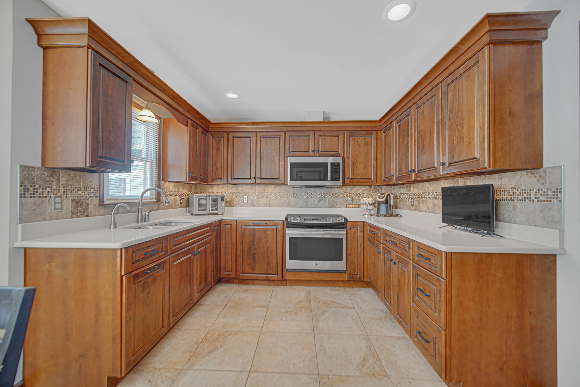 130 Wheatridge Road Valparaiso, IN 46385 - Photo 11 of 38 a kitchen with stainless steel appliances granite countertop a stove sink and cabinets