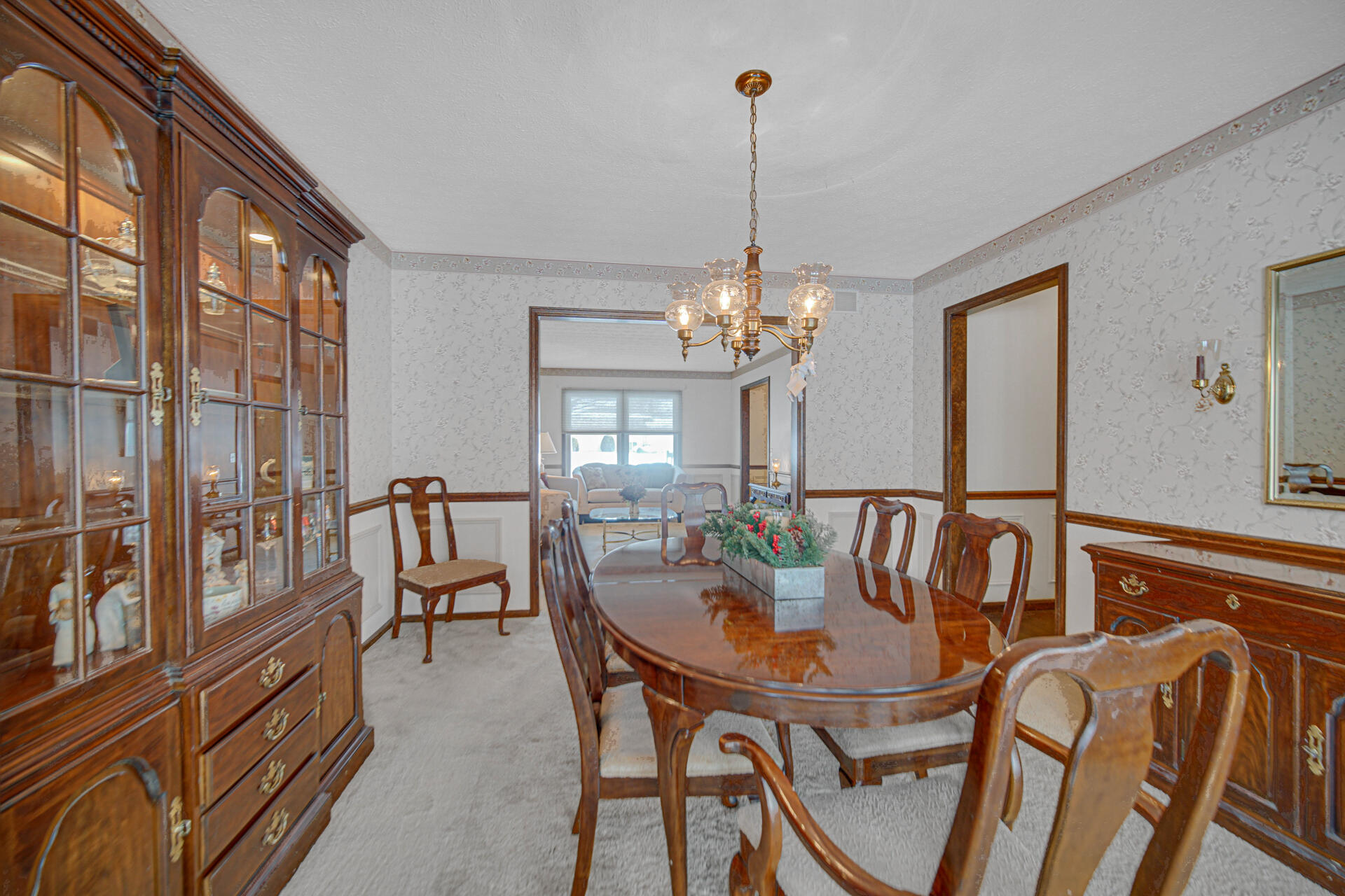 130 Wheatridge Road Valparaiso, IN 46385 - Photo 16 of 38 a dining room with furniture a chandelier and wooden floor