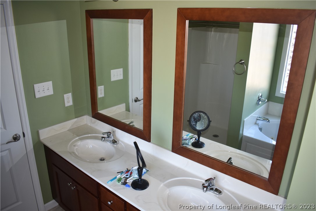 76 Ithica Lane Bunnlevel, NC 28323 - Photo 27 of 49 a bathroom with 2 sink and a mirror