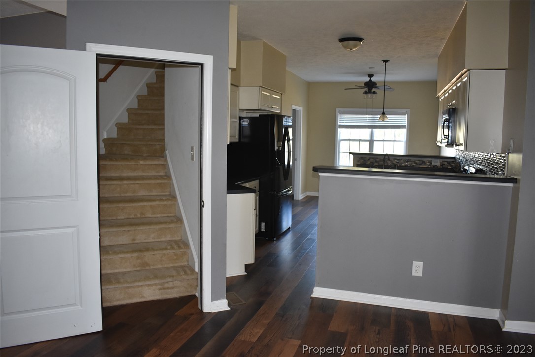 76 Ithica Lane Bunnlevel, NC 28323 - Photo 37 of 49 a view of a hallway with wooden floor and staircase