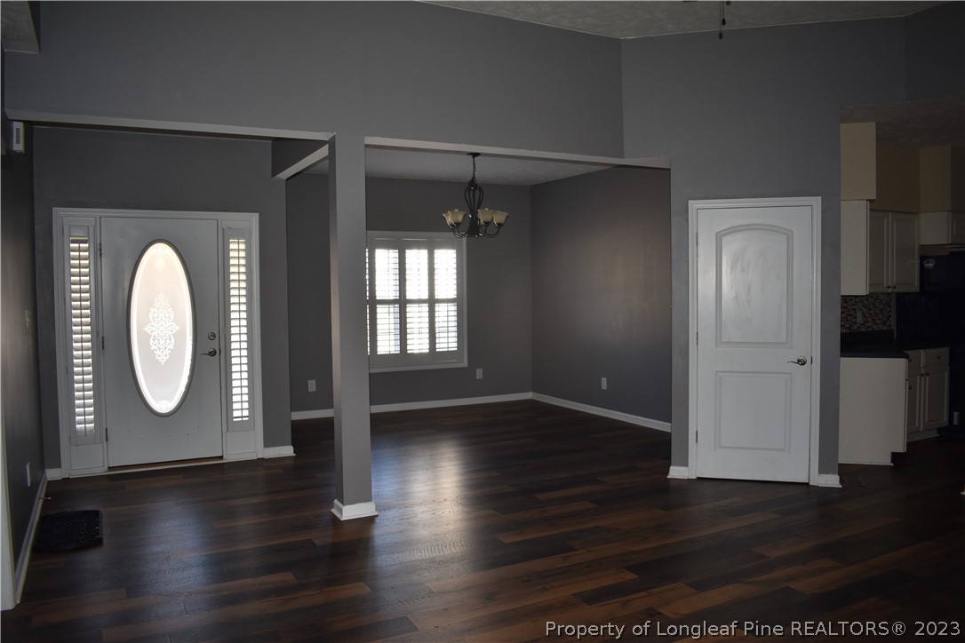 76 Ithica Lane Bunnlevel, NC 28323 - Photo 5 of 49 an empty room with wooden floor mirror and windows