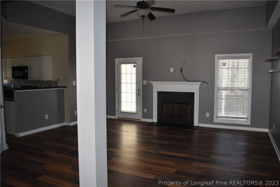 76 Ithica Lane Bunnlevel, NC 28323 - Photo 6 of 49 an empty room with wooden floor a fireplace and windows