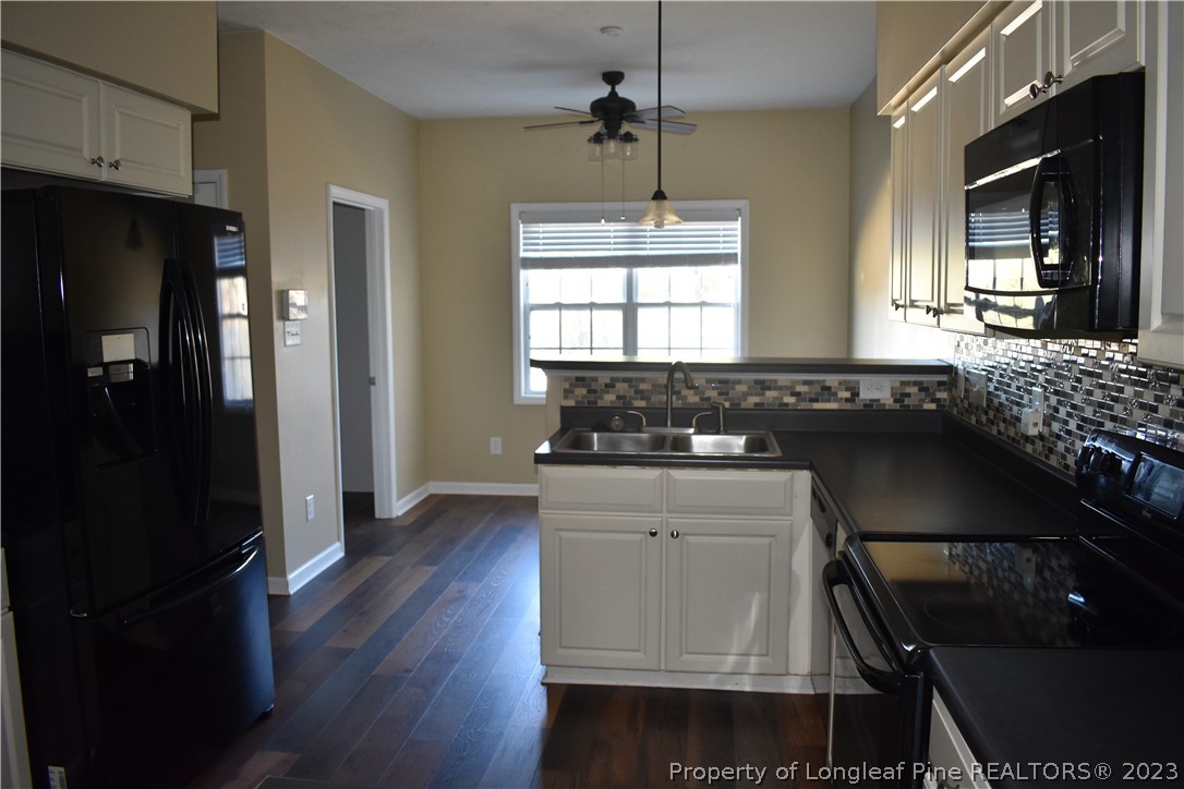 76 Ithica Lane Bunnlevel, NC 28323 - Photo 10 of 49 a kitchen with a sink stove and refrigerator