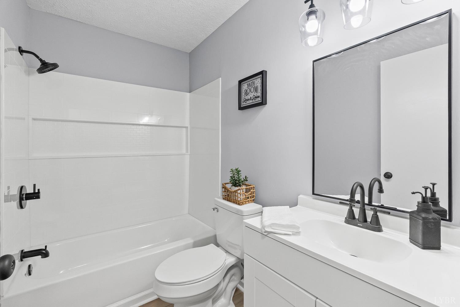 1077 Ringgold Road Ringgold, VA 24586 - Photo 12 of 35 a bathroom with a sink a toilet a mirror and shower