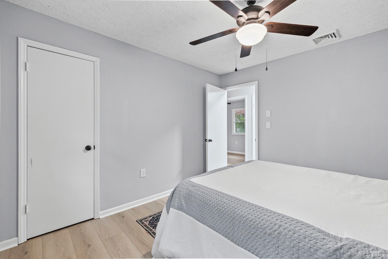 1077 Ringgold Road Ringgold, VA 24586 - Photo 18 of 35 a bedroom with a bed and a chandelier