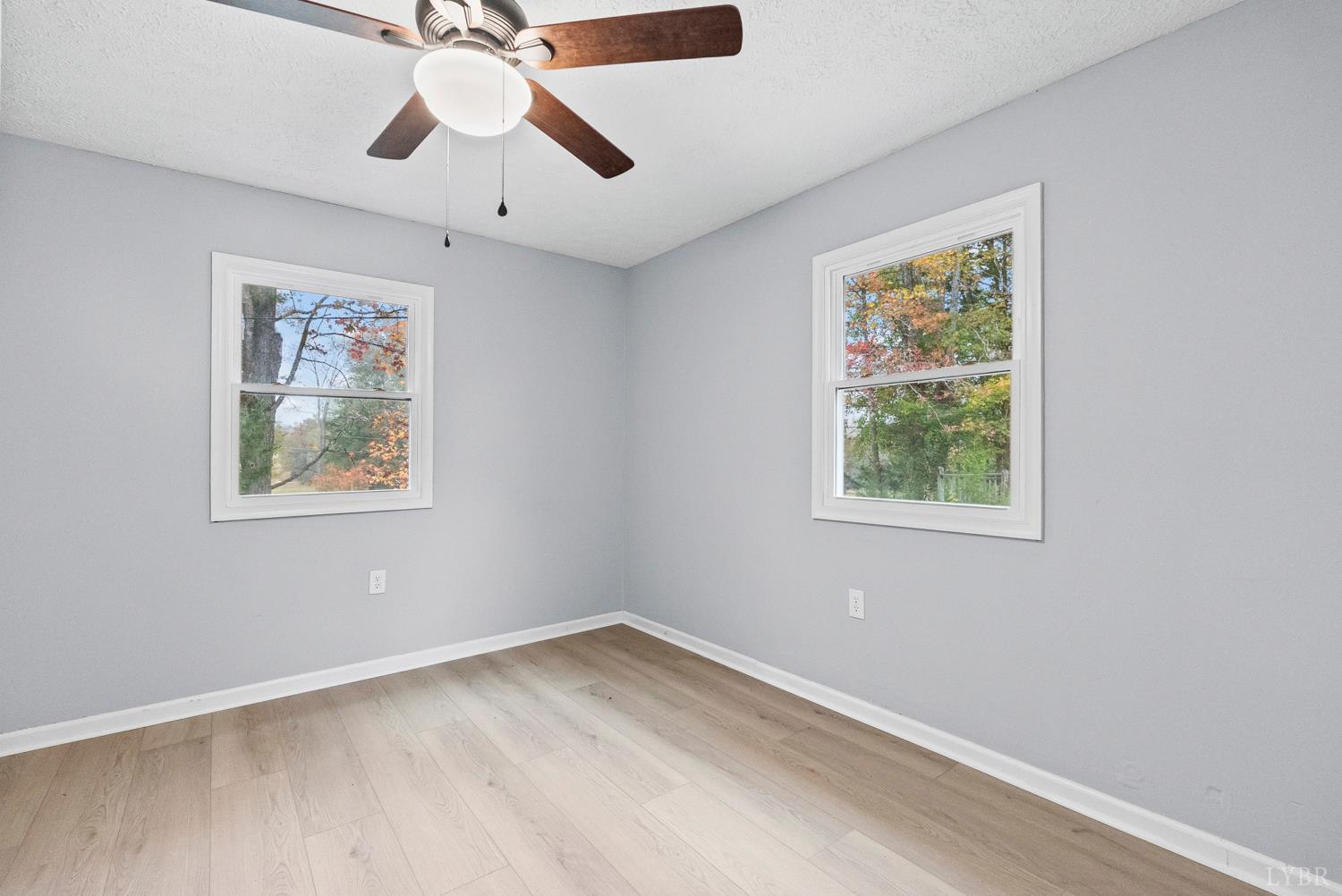 1077 Ringgold Road Ringgold, VA 24586 - Photo 19 of 35 an empty room with a window and a ceiling fan