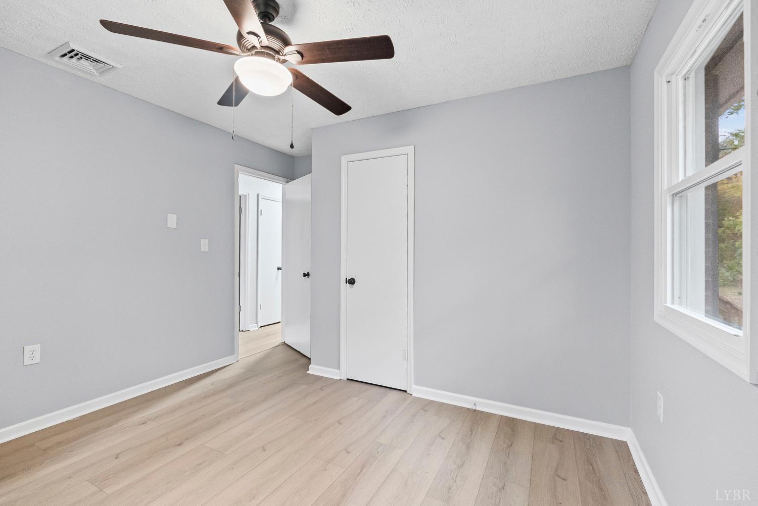 1077 Ringgold Road Ringgold, VA 24586 - Photo 21 of 35 wooden floor in an empty room with a window
