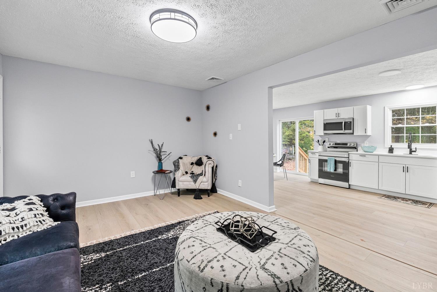 1077 Ringgold Road Ringgold, VA 24586 - Photo 27 of 35 a bedroom with furniture and a wooden floor