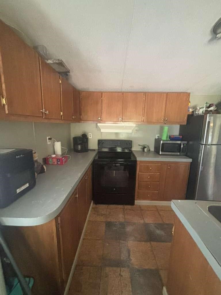 301 Morocco Drive Point Blank, TX 77364 - Photo 2 of 7 a kitchen with a sink a stove and cabinets