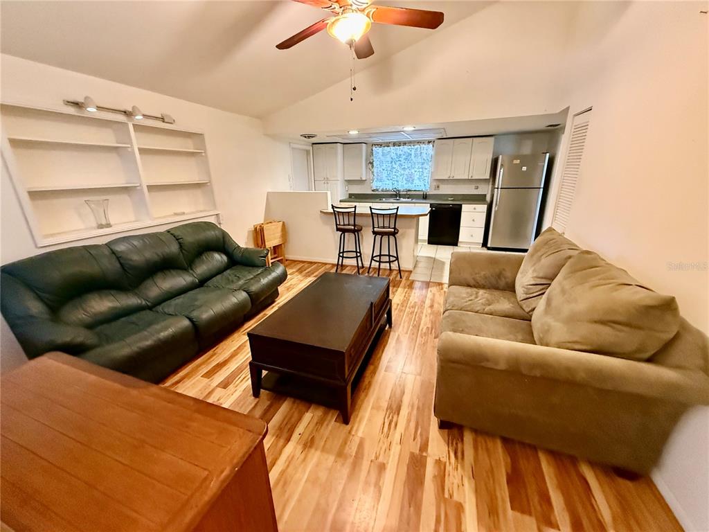 1004 Connecticut Road Tarpon Springs, FL 34689 - Photo 23 of 57 a living room with furniture and a fireplace