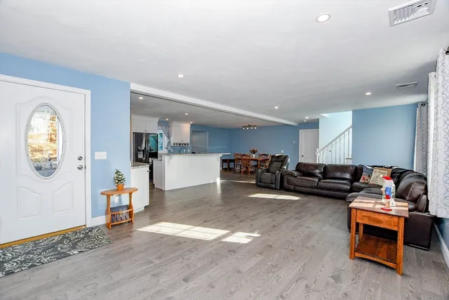 a living room with furniture and kitchen view