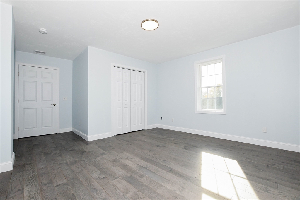 9 Old Glen Charlie Road Wareham, MA 02538 - Photo 32 of 42 an empty room with wooden floor and windows