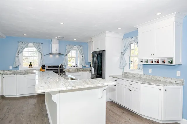 a kitchen with stainless steel appliances granite countertop a sink stove and cabinets