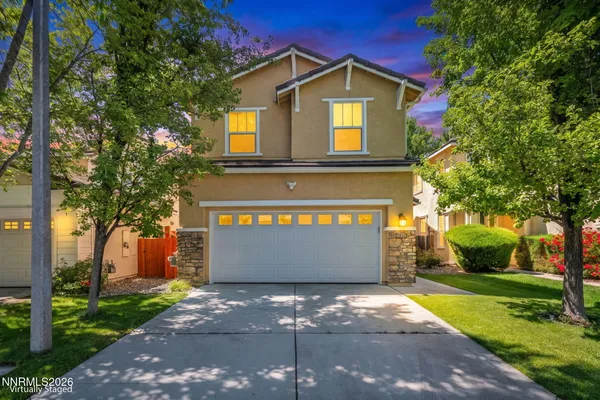 a front view of a house with a yard and garage