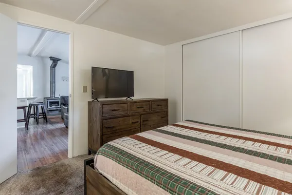 a bedroom with a bed and a flat screen tv