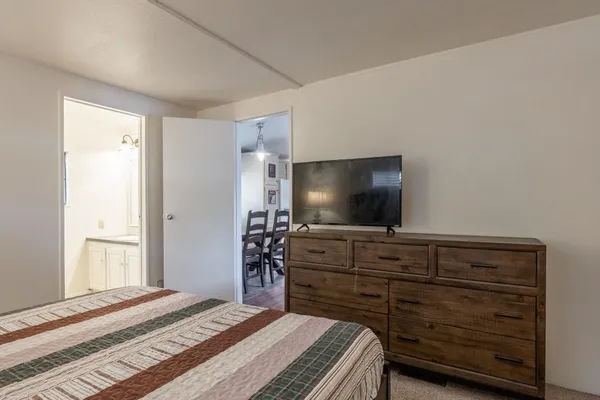 a bedroom with a bed and a mirror