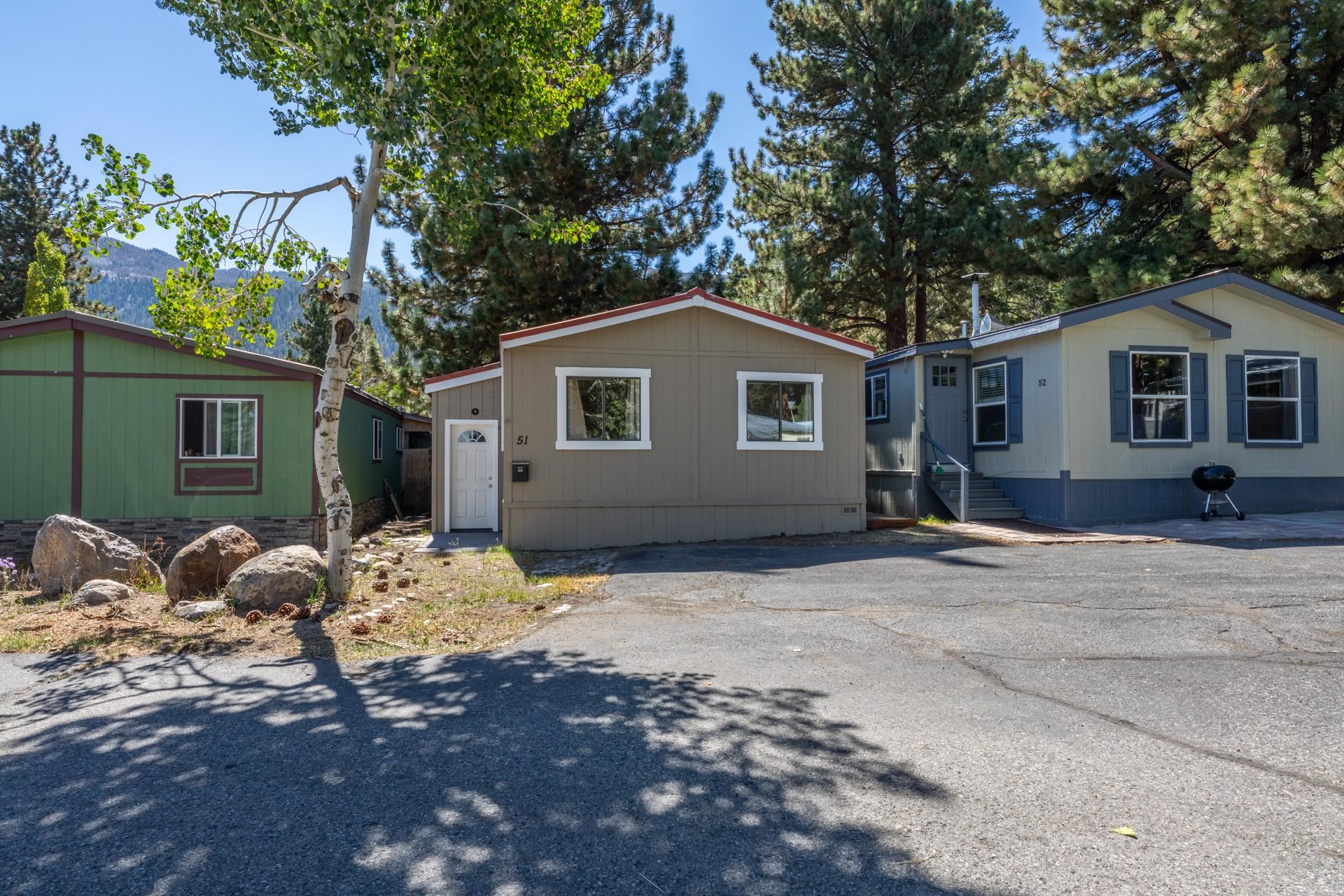 100 Ski Trails Road, Unit 51 Mammoth Lakes, CA 93546 - Photo 23 of 28 a backyard of a house with table and chairs and potted plants