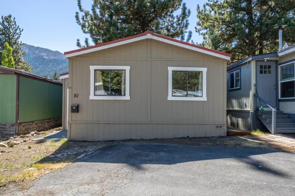 a view of a house with a backyard