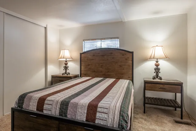 a bedroom with a bed and a lamp