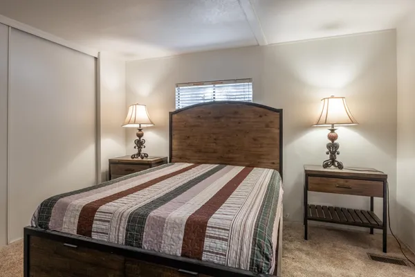 a bedroom with a bed and a lamp