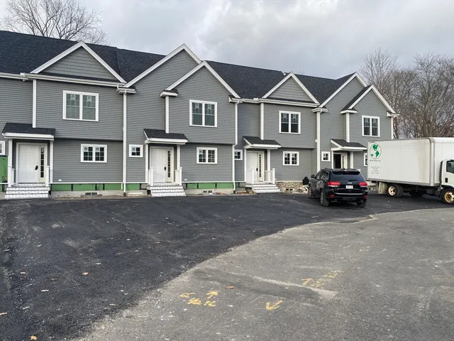 a front view of a house with a street