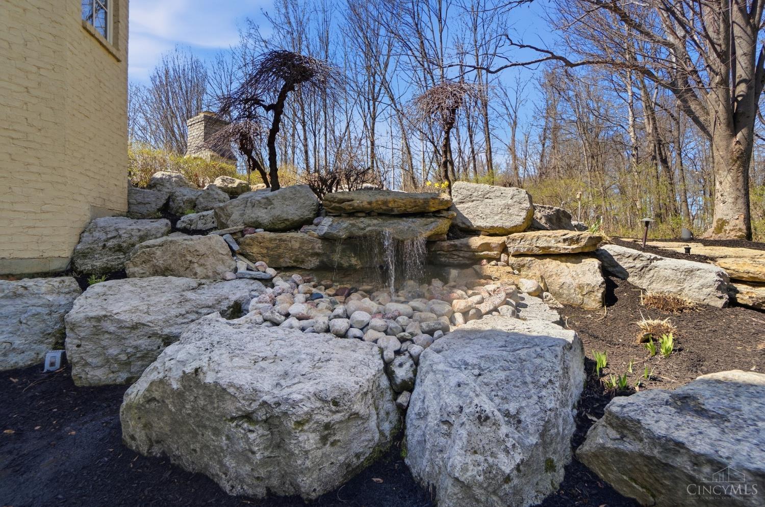 1054 Observatory Point Maineville, OH 45039 - Photo 69 of 82 Gentle waterfall right outside the walkout lower level doors adjacent to the lower level patio.