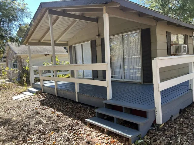 a view of a house with a wooden deck