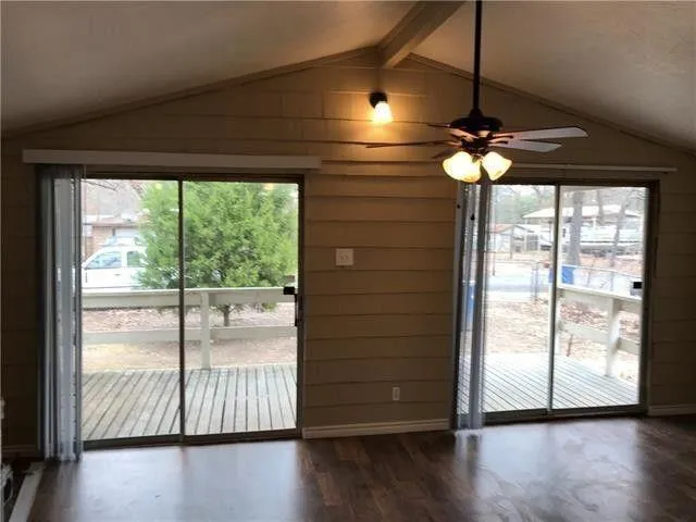 a view of room with wooden floor and fan
