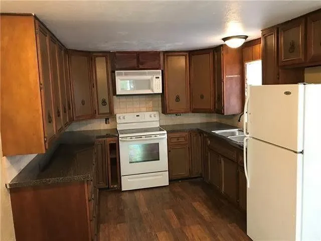 a kitchen with a refrigerator stove and sink