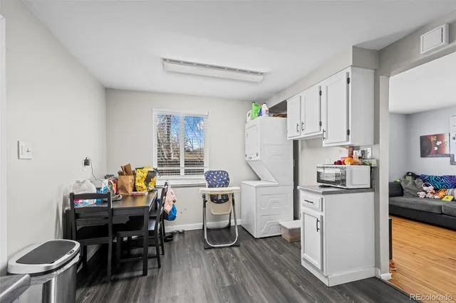 a kitchen with stainless steel appliances a table chairs and a refrigerator