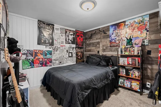 a bedroom with a bed a book shelf and a window