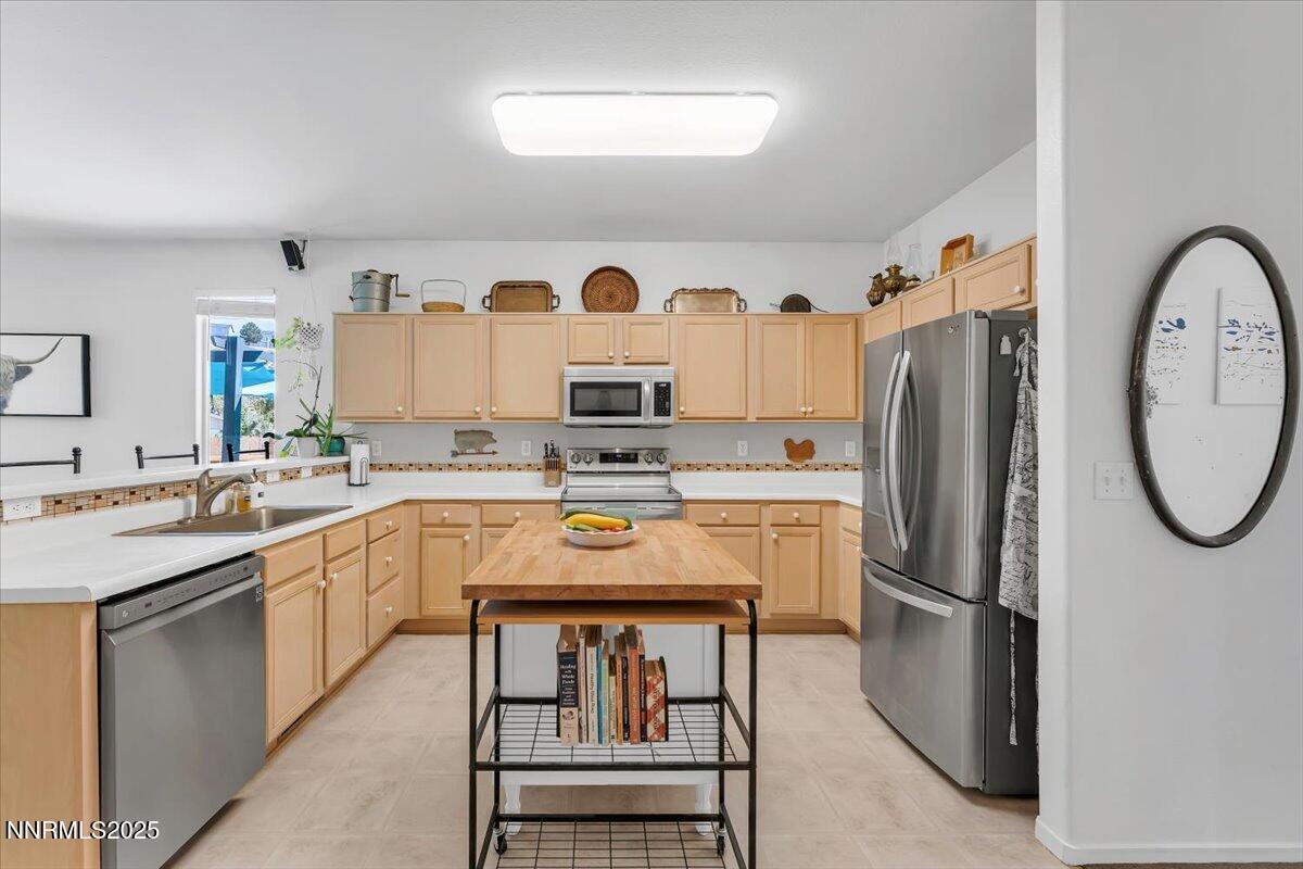 5921 Sapphire Ridge Court Reno, NV 89523 - Photo 12 of 31 a kitchen with stainless steel appliances granite countertop a refrigerator a sink a stove and white cabinets with wooden floors