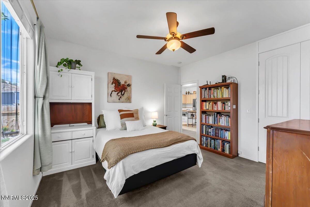 5921 Sapphire Ridge Court Reno, NV 89523 - Photo 16 of 31 a bedroom with a bed a book shelf and a window
